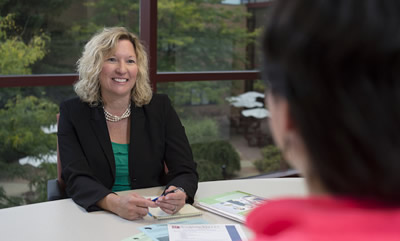 Heidi Lang talking to student